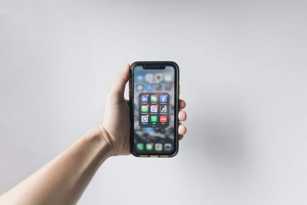Best IPTV Player Apps Compared (2026) Hand holding a smartphone with blank screen