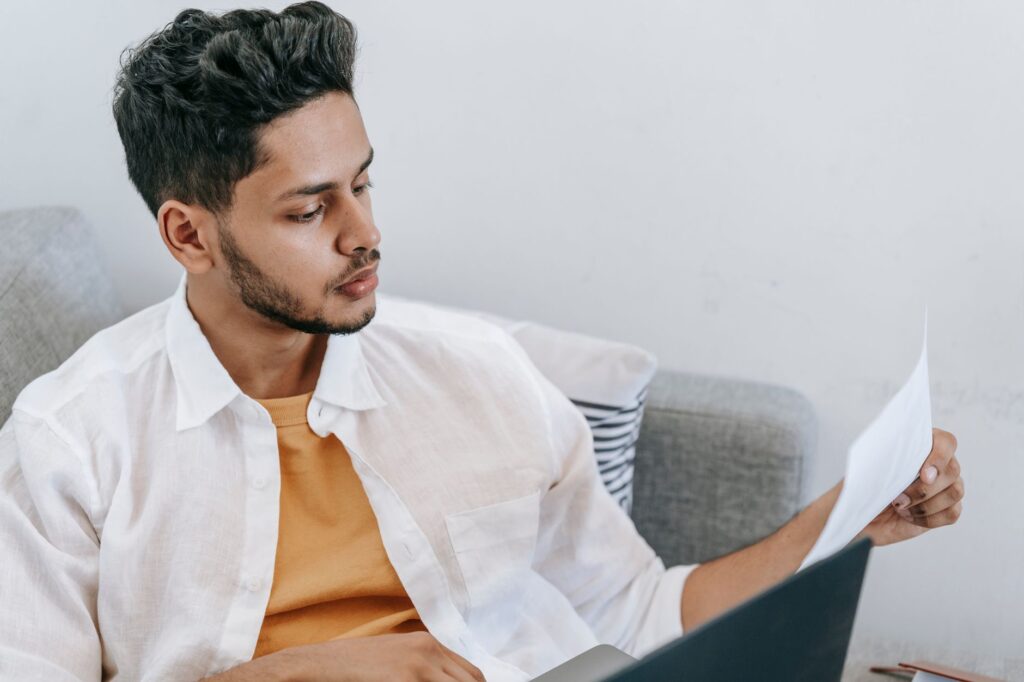 Is IPTV Legal? A Clear, Honest Answer Man reading a printed document carefully