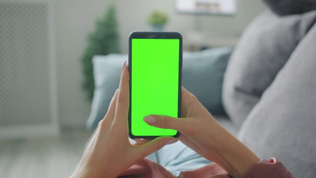 IPTV Smarters Pro: Complete Guide (Windows, Mac, Mobile & More) Smartphone held in hand with plain green screen