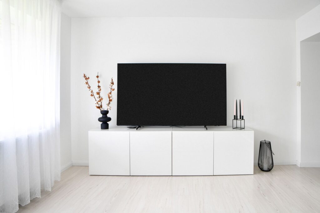 What Is IPTV? The Complete Guide Modern flat screen TV on a white console