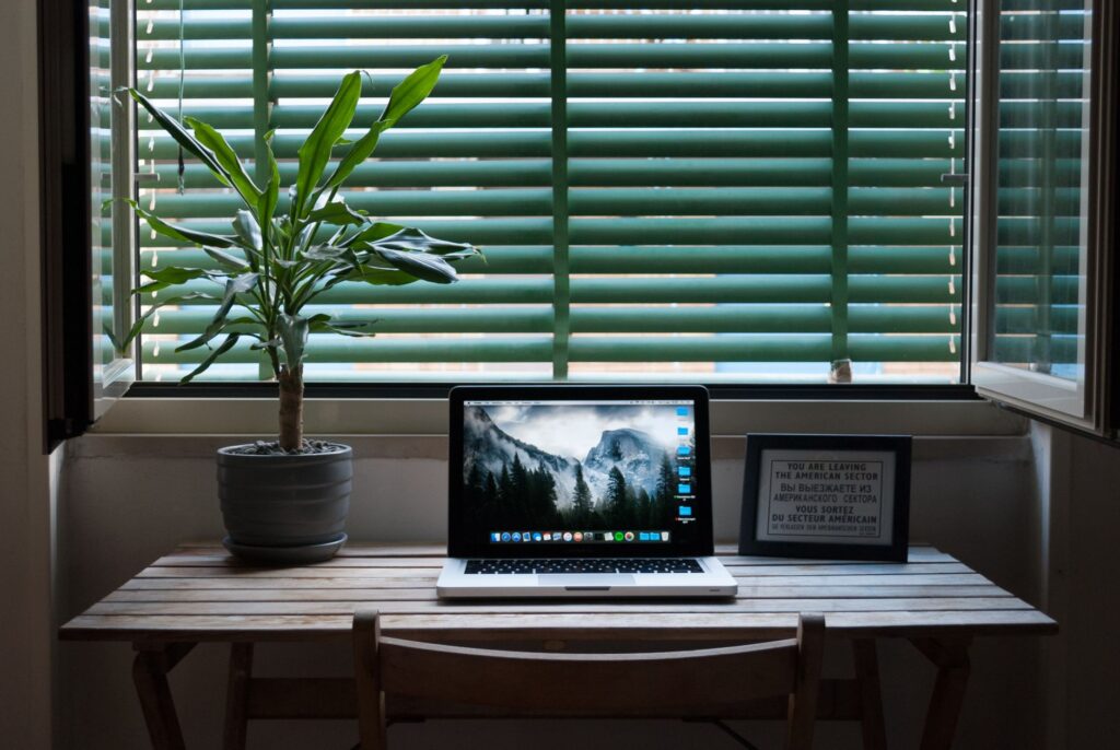 New to IPTV? Your Complete Getting-Started Checklist Laptop on a desk near a window with a plant